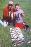 Petros with his grandson, Spencer, and a catch of Illinois panfish.