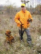 Jerry Dennis, Traverse City, Michigan, displays a grouse he shot, flushed and retrieved by Gabe, the author’s golden retriever. Photo: Dave Mull