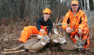 ‘Quick, hide Ken’s rifle,’ someone in camp whispered, while this photo was being taken. Pictured (left to right) are Doc’s grandson, Ryan, Doc’s youngest son, Ken, and the three bucks taken by Ken Nordberg three seasons ago. All were taken from stand sites near very fresh buck tracks.