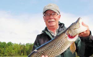 Legendary Rainy guide Mike Williams with a lengthy ice-out pike.