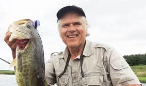 Swimming a 1/4-ounce Dragon Hopper with a 2/0 sprout worm hook and Texas-rigged Pit Boss Jr. over heavy coontail weeds, help produce this lunker bass as the lure dropped on a fall over the outer edge of a weedline. 