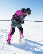 Sarah Englebert drills holes with a lightweight auger.