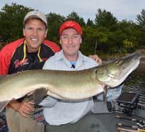 Jim Saric and John Cowan with a muskie caught from a new water they never fished previously, but one they researched during the winter months.
