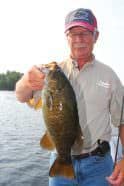 Rainy Lake fishing guide Mike Williams holds a trophy smallmouth caught in the shallows. Photo: Roger Cormier
