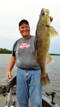 Fisherman holding a 32-inch walleye recently caught from Witch Bay.