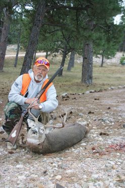 Hunter L.P. Brezny with a downed whitetail deer and the Hawken muzzleloader rifle.