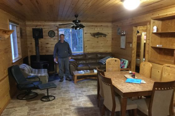 Interior of one of the pine log fishing cabins available at Woman River in Ontario.