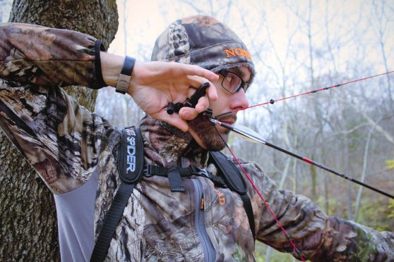 Deer hunter and writer Tim Kjellesvik at full draw for deer hunting.