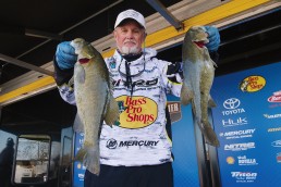 Rick Clunn has been hooking huge bass his entire life. Here, he displays two fine catches of the day.