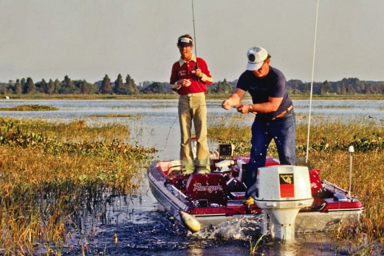 Rick Clunn fishing from a boat with his fishing partner in the seventies.