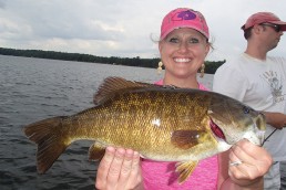 Never leave active bass to seek greener pastures elsewhere. Guide customer Andrea Luszcak displays one of more than 60 bass boated on this July day.